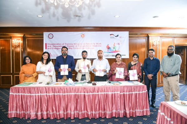 Guests stand together holding the OD and RTW training manuals.