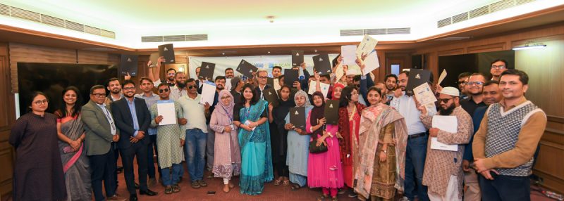 Group photo of graduates with disabilities holding their certificates with representatives from BRAC Bank, BBDN, B-SCAN, Creative IT Institute and Skill Jobs (Daffodil Group) at the certificate presentation ceremony.